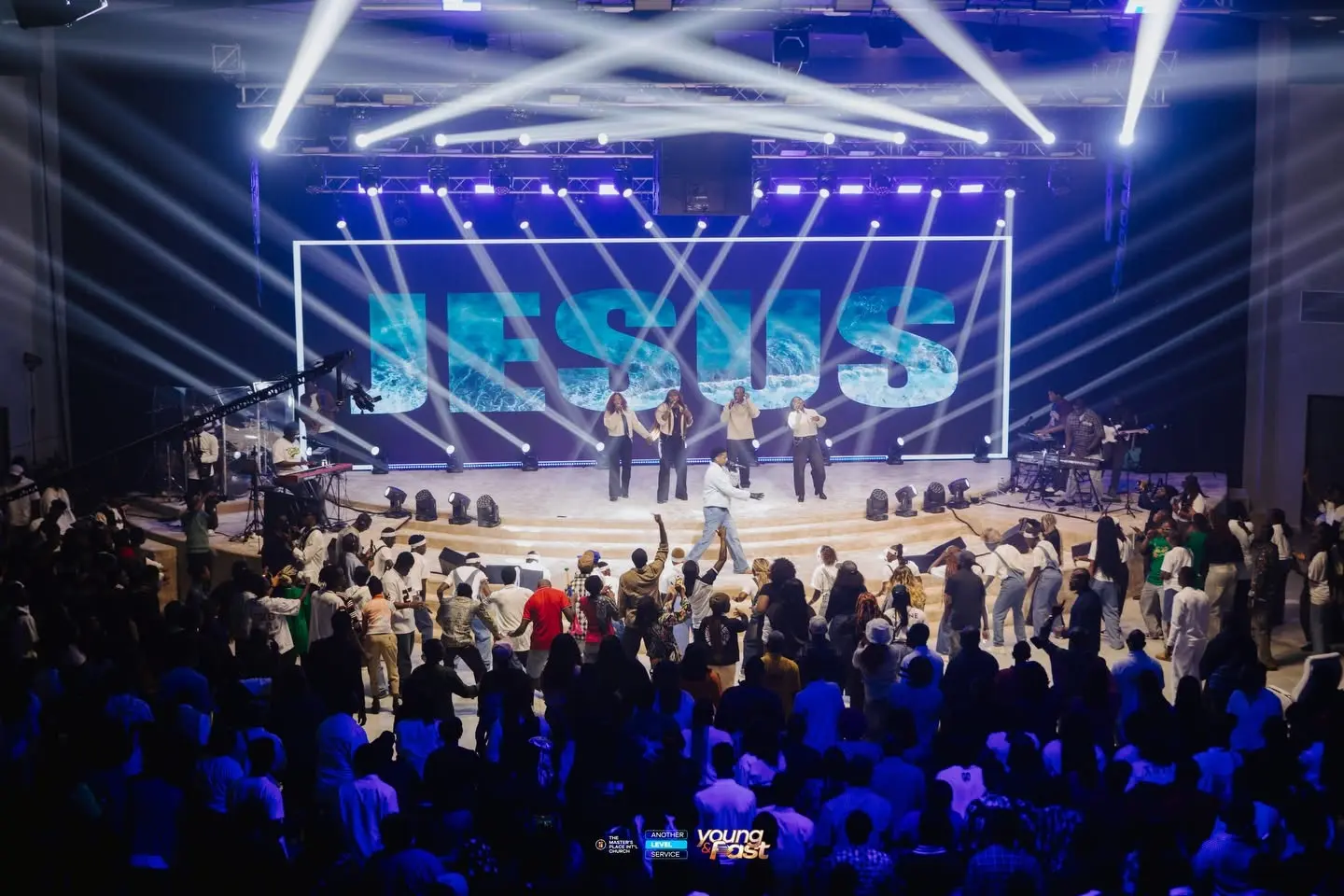 Large event stage with LED backdrop, lighting and audience